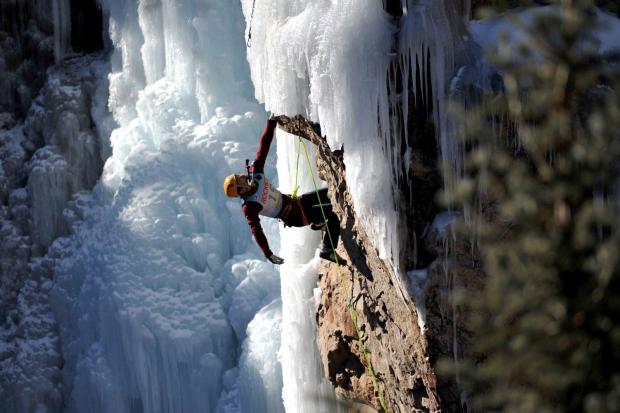 Ryan Kim rest and searches for a hold while suspended over 100 feet above Box Canyon in Ouray Colo., Saturday Jan. 11, 2014, during the annual Ouray Ice Festival Elite Mixed Climbing Competition. (William Woody, Special to The Denver Post)