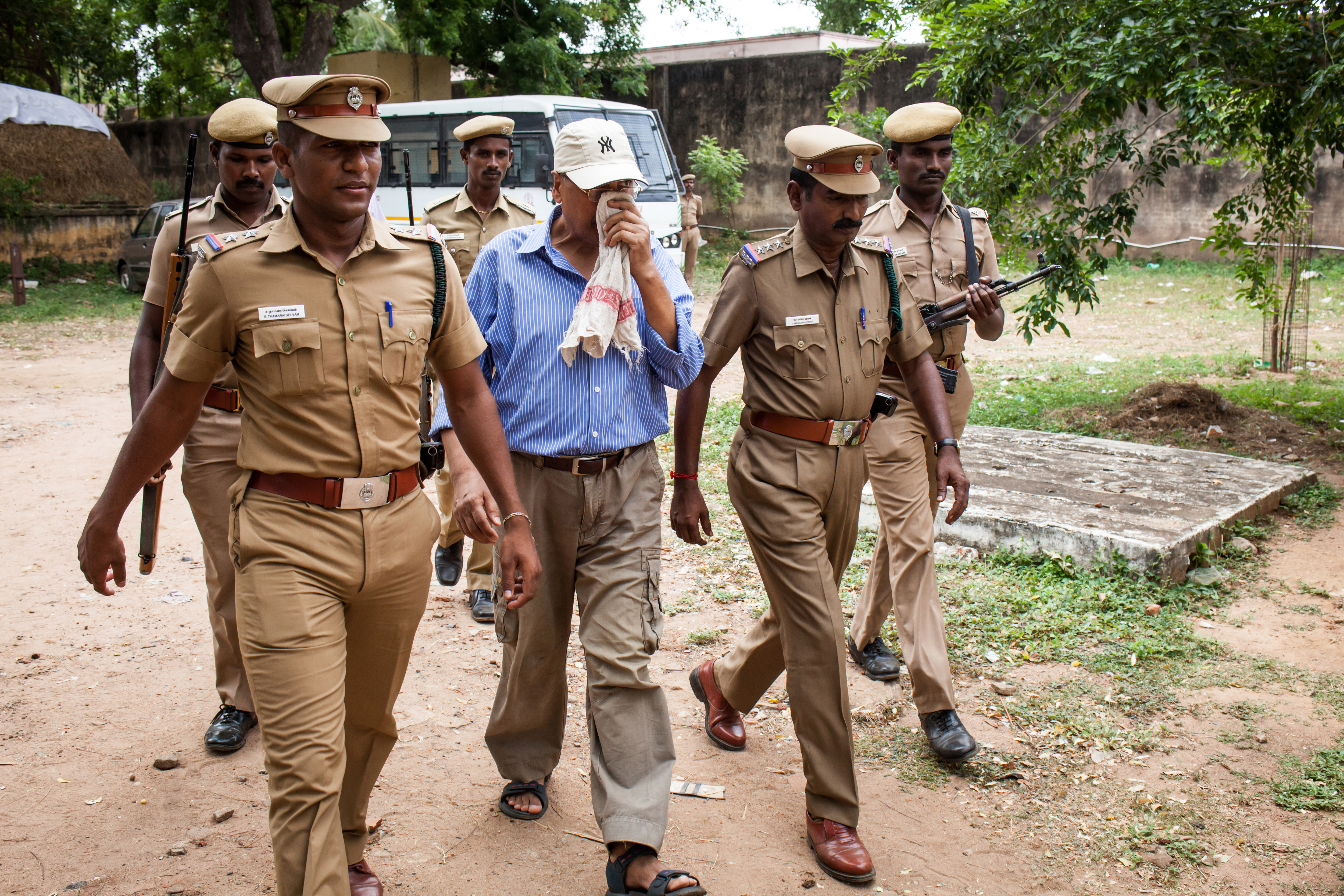 Subhash Kapoor is escorted to court by police in Jeyamkondam, India, on July 8, 2015. Kapoor, a former Madison Avenue art dealer whom investigators had identified as a major antiquities smuggler, has been convicted and sentenced to prison in India on burglary and illegal export charges in Nov. 2022. (Amirtharaj Stephen/The New York Times)