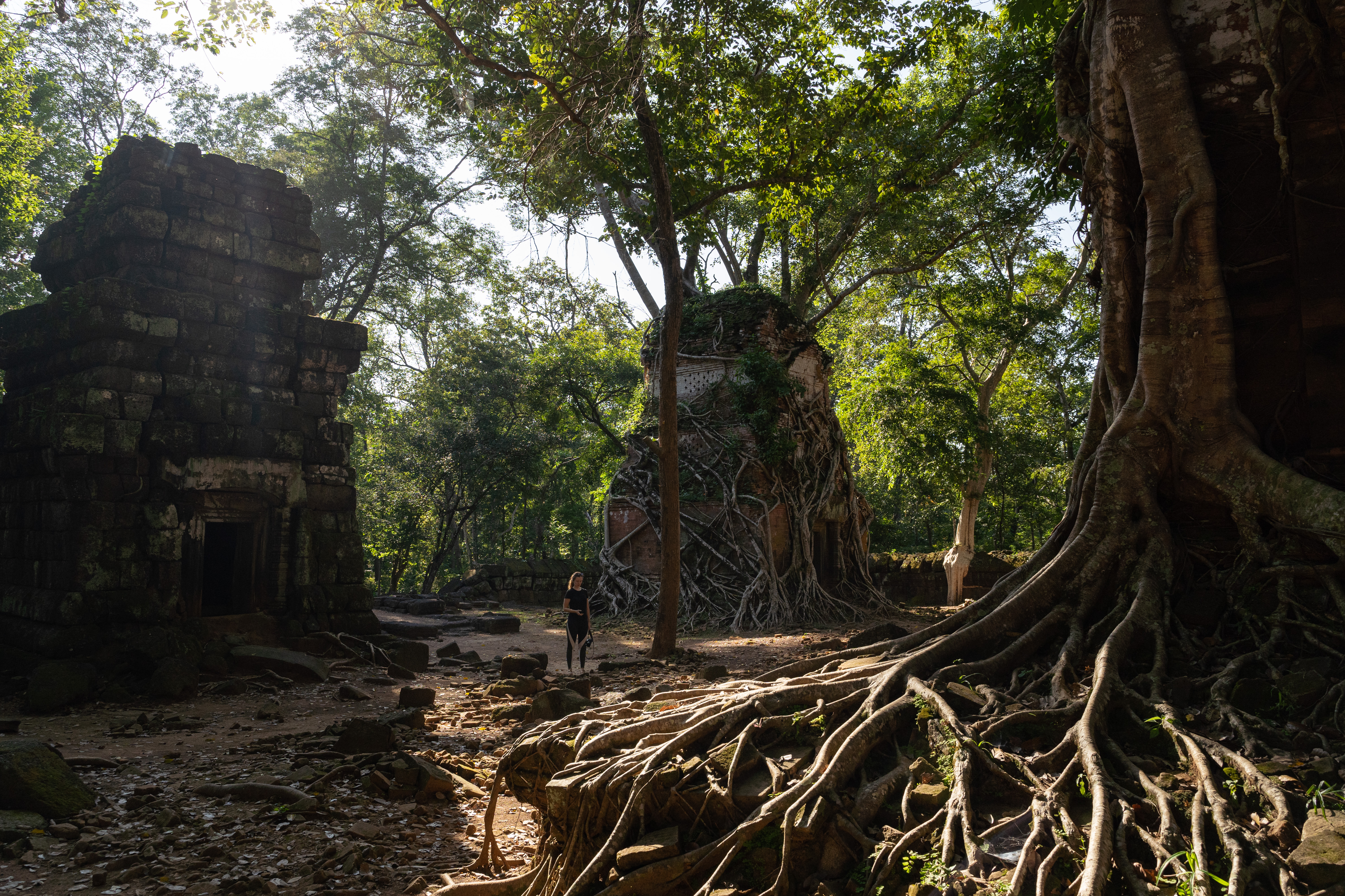 A woman stands among the structures at Koh Ker on Oct. 26, 2019. (Photo by Thomas Cristofoletti, Ruom/Special to The Denver Post)
