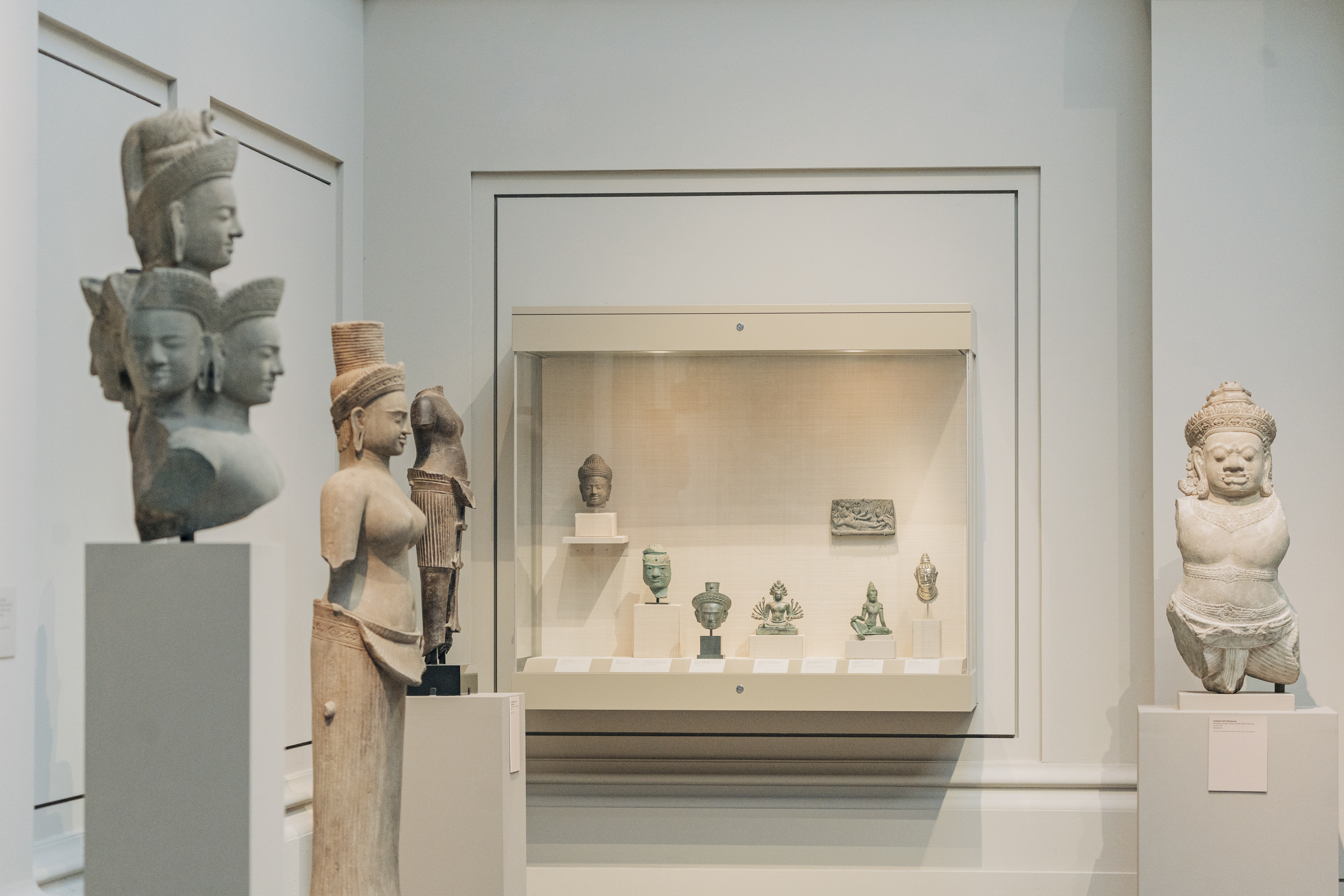 Antiquities on display in Gallery 249 at The Metropolitan Museum of Art, Manhattan, on July 29, 2022. Cambodia says it suspects that a half dozen objects on display in this corner of Gallery 249 were looted, including two artifacts that were given to the Met by British-Thai businessman and collector Douglas Latchford. (Jeenah Moon/The New York Times)