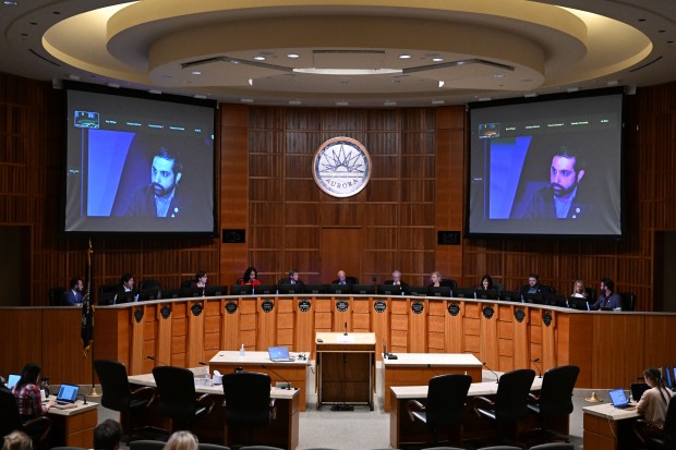 Members of the Aurora City Council meet during their weekly city council meeting in the City Council Chambers