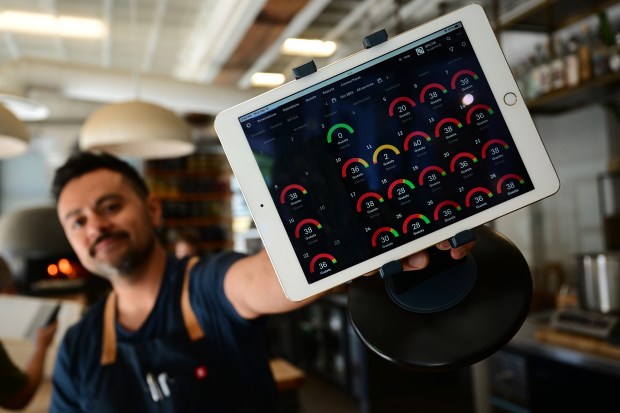 Brutø executive chef Michael Diaz de Leon shows his iPad with an explosion of online reservations just hours after his restaurant was awarded a Michelin star. (Photo by Helen H. Richardson/The Denver Post)
