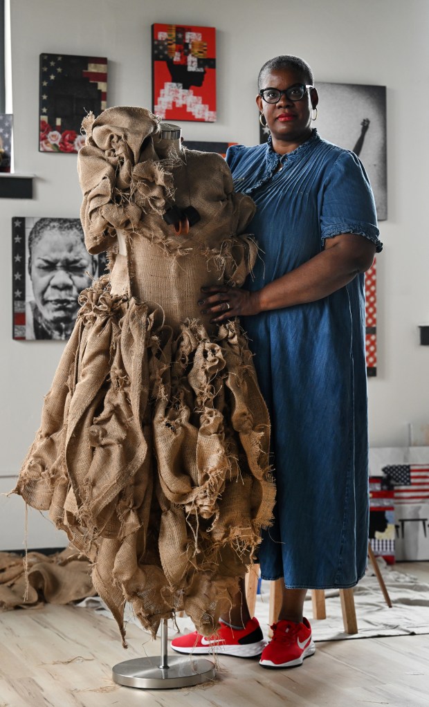 Chloé Duplessis stands next to a burlap dress that she is making for her  upcoming show Sista Soldier in her studio at East Street School in Trinidad on September 11, 2023. (Photo by Helen H. Richardson/The Denver Post)