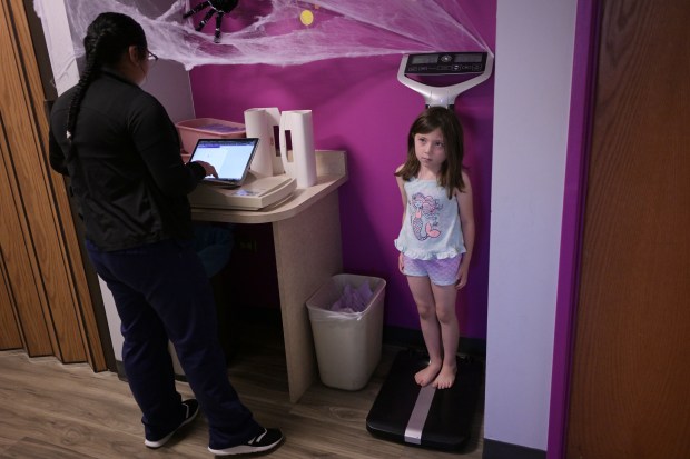 Medical Assistant Yoanna Ortega, left, checks the weight of Olivia Aller, 5, at Every Child Pediatrics at HealthONE Presbyterian/St. Luke's Medical Center in Denver on Tuesday, Oct. 17, 2023. (Photo by Hyoung Chang/The Denver Post)