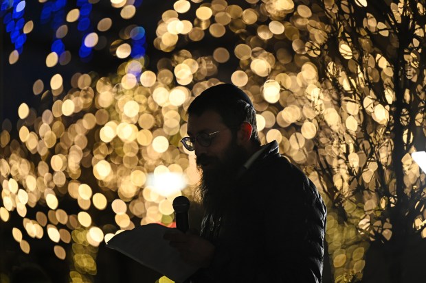 Rabbi Shmuly Engel addresses people gathered to watch the lighting of the large menorah outside of the Chabad of Cherry Creek on Dec. 10, 2023, in Denver. The Chabad of Cherry Creek held a lighting event outside on its plaza at 250 Fillmore street. (Photo by Helen H. Richardson/The Denver Post)
