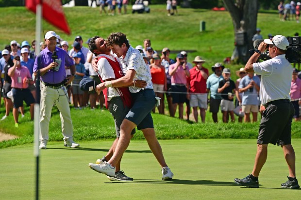 Nick Dunlap, of Huntsville, AL, hugs his caddy Jeff Curl, left, celebrate Dunlaps win on Hole 15 against Neal Shipley, of Pittsburg, PA during the final match play at the 123rd U.S. Amateur Championship at the Cherry Hills Country Club in Cherry Hills Village, Colorado on Aug. 20, 2023 in Cherry Hills Village Colorado. Dunlap beat Shipley 4 and 3 in the match up to take home the win.