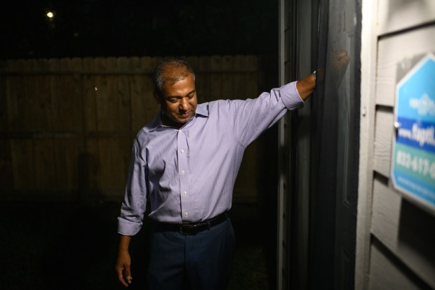 Landlord Jamil Hasan, who rents to people leaving homelessness through Houston's homeless response system, knocks on a tenant's door in Houston on Oct. 12, 2023. (Photo by Mark Felix/Special to The Denver Post)