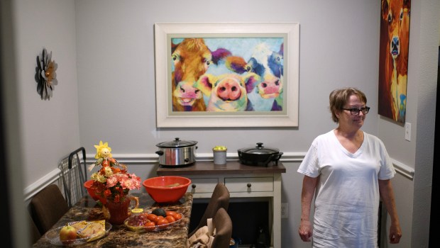 Teresa Eddins, 63, walks through her apartment in Houston