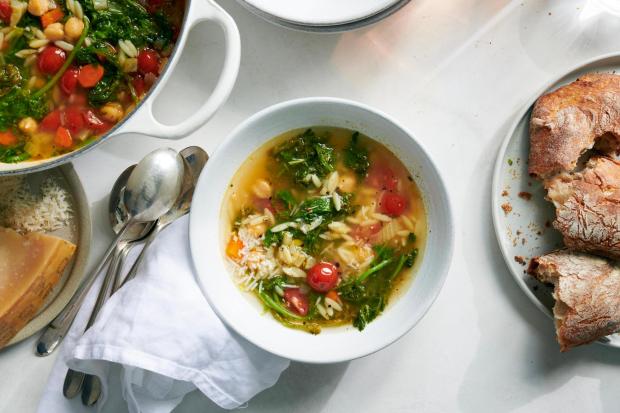 Chickpea stew with orzo and mustard greens. This 30-minute stew from Melissa Clark is packed with vegetables and gilded with the amplifying flavor of Parmesan cheese. Food styled by Simon Andrews. (David Malosh, The New York Times)