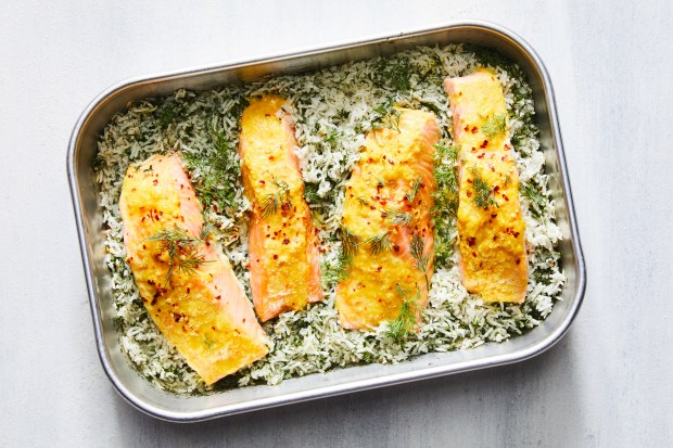 Baked salmon and dill rice. A large handful of emerald-green dill makes this dish from Naz Deravian as pretty as it is fragrant.  Food styled by Rebecca Jurkevich. (Linda Xiao, The New York Times)